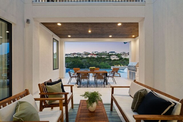 balcony featuring outdoor dining space, an outdoor hangout area, an outdoor kitchen, area for grilling, and a patio