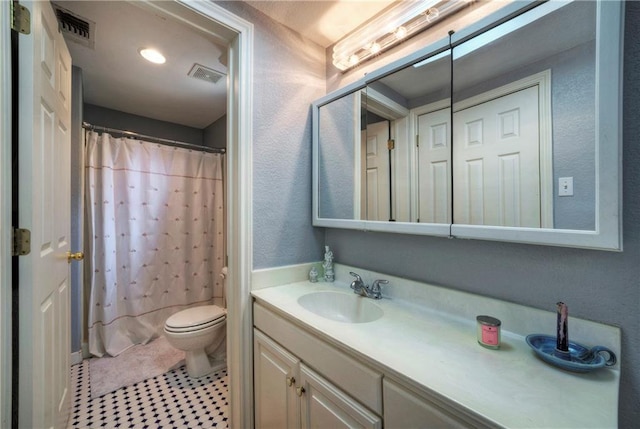 bathroom featuring toilet, visible vents, curtained shower, and vanity