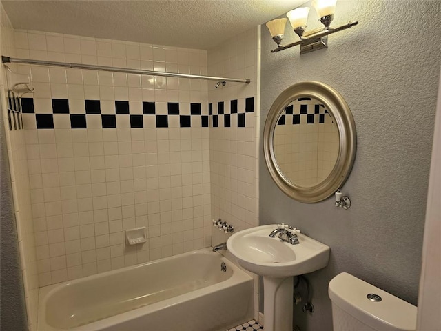bathroom with toilet, a textured ceiling, shower / washtub combination, and a textured wall