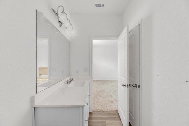 bathroom with vanity, wood finished floors, and visible vents