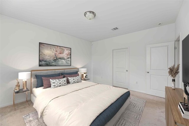 bedroom featuring light colored carpet and visible vents