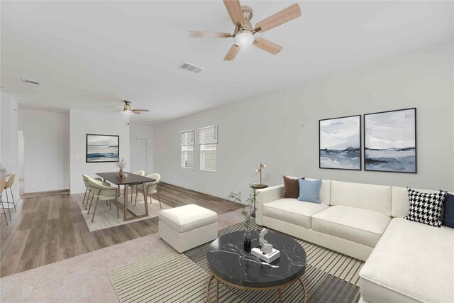 living area with ceiling fan, visible vents, and light wood finished floors