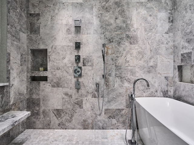 full bathroom featuring tile walls, a freestanding bath, and tiled shower