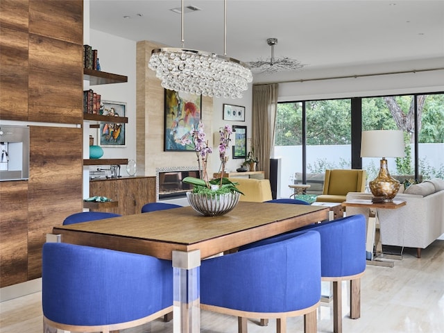 dining area featuring a chandelier, wood finished floors, and visible vents