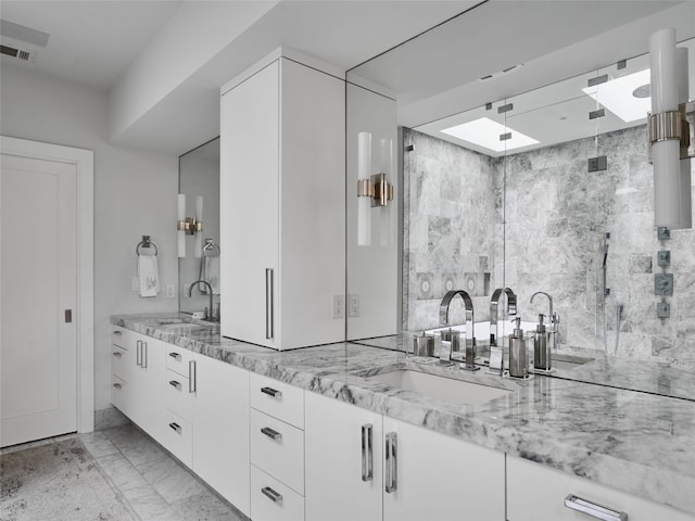full bathroom with double vanity, visible vents, a stall shower, a sink, and marble finish floor