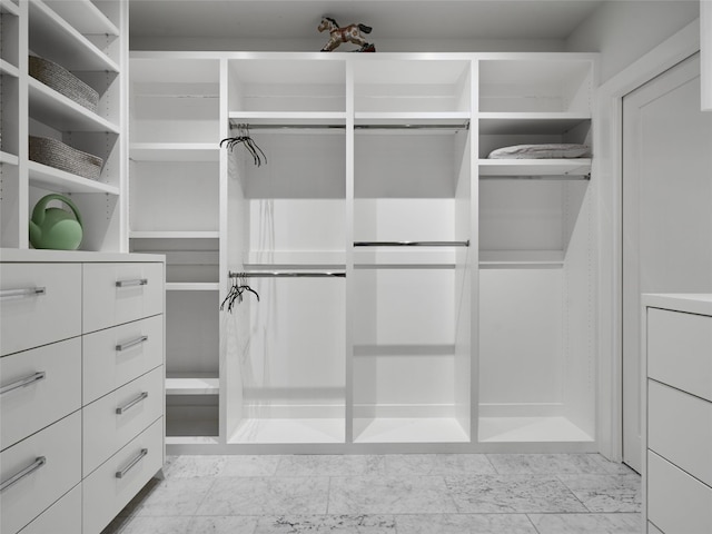 spacious closet with marble finish floor