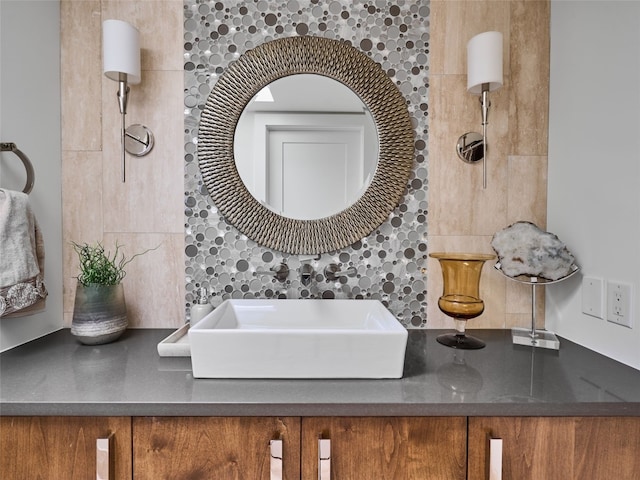 bathroom with a sink and backsplash