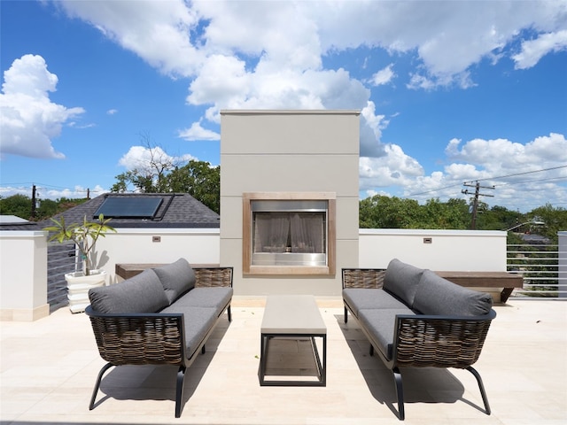 view of patio featuring an outdoor living space with a fireplace
