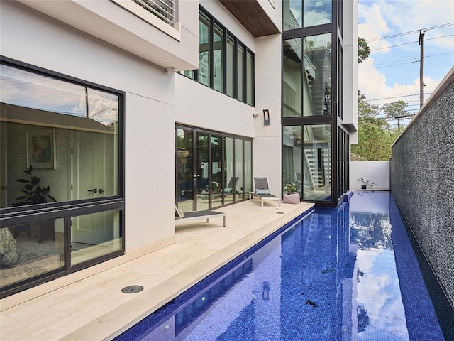 view of swimming pool with a fenced in pool and a patio area
