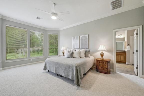 carpeted bedroom with crown molding, a ceiling fan, baseboards, and visible vents
