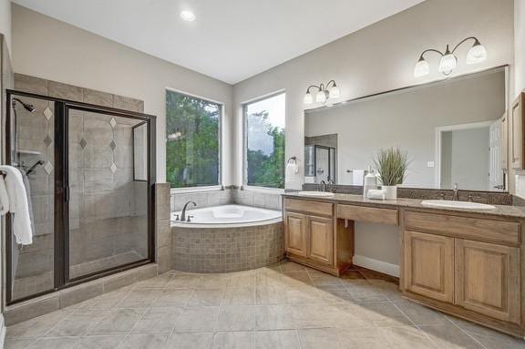 bathroom with a sink, a garden tub, a stall shower, and double vanity
