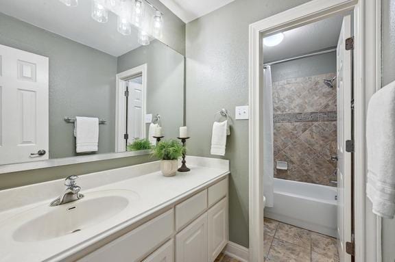 bathroom with shower / tub combo with curtain and vanity