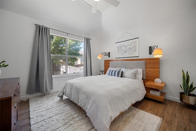 bedroom with baseboards, ceiling fan, and wood finished floors