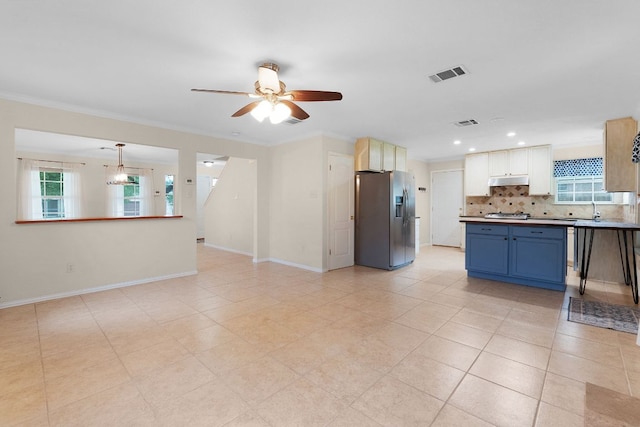 1809 Woodland Dr, Cedar Park, TX 78613 - kitchen with decorative backsplash, a ceiling fan, blue cabinets, visible vents, and appliances with stainless steel finishes