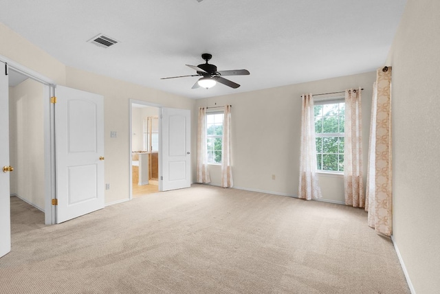 1809 Woodland Dr, Cedar Park, TX 78613 - unfurnished bedroom featuring visible vents, light carpet, baseboards, ensuite bathroom, and a ceiling fan