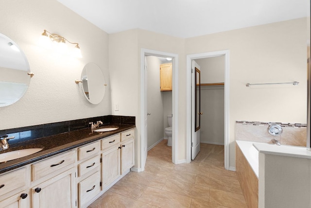 1809 Woodland Dr, Cedar Park, TX 78613 - bathroom with a sink, double vanity, toilet, and a bath