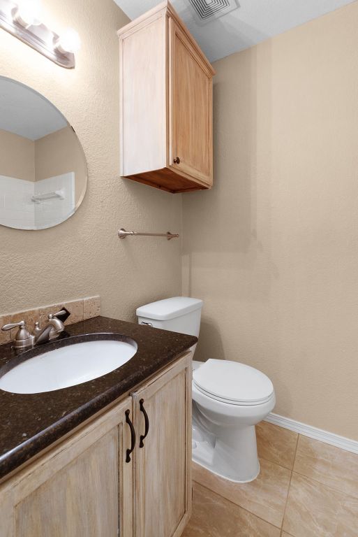 1809 Woodland Dr, Cedar Park, TX 78613 - bathroom featuring vanity, tile patterned flooring, visible vents, and toilet