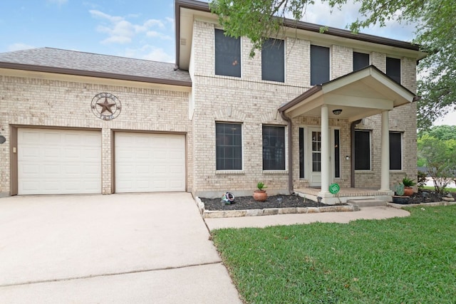 1809 Woodland Dr, Cedar Park, TX 78613 - view of front of home with an attached garage, concrete driveway, a front yard, and brick siding