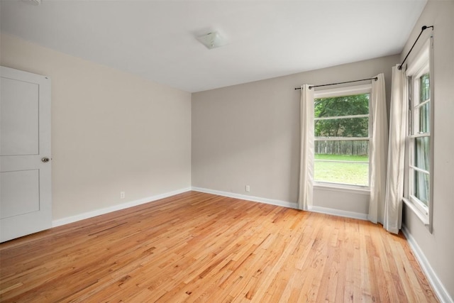 empty room featuring light wood-style floors and baseboards