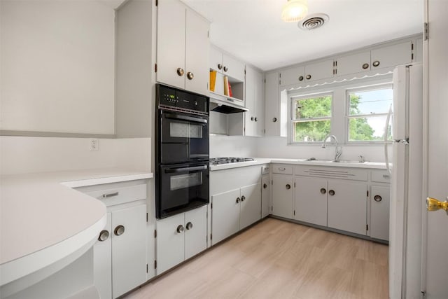 kitchen featuring open shelves, gas cooktop, a sink, dobule oven black, and visible vents