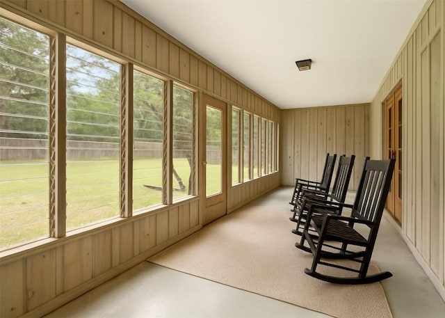 sunroom / solarium featuring wood walls