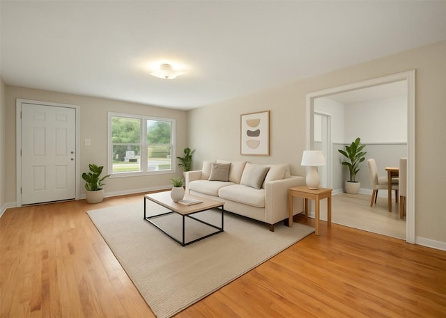 living room featuring baseboards and light wood finished floors