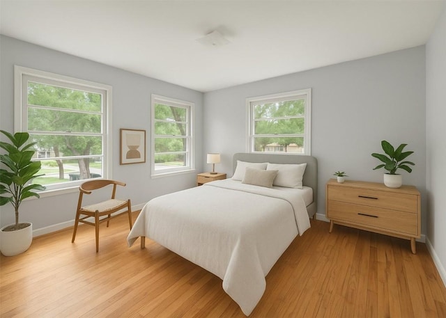bedroom featuring baseboards and light wood-style flooring