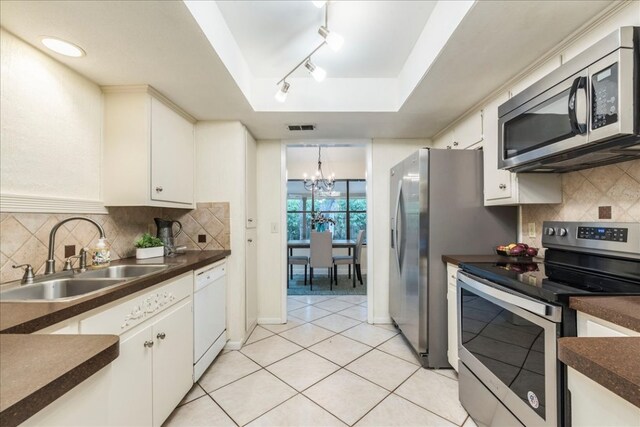 kitchen with visible vents, a sink, dark countertops, and stainless steel appliances