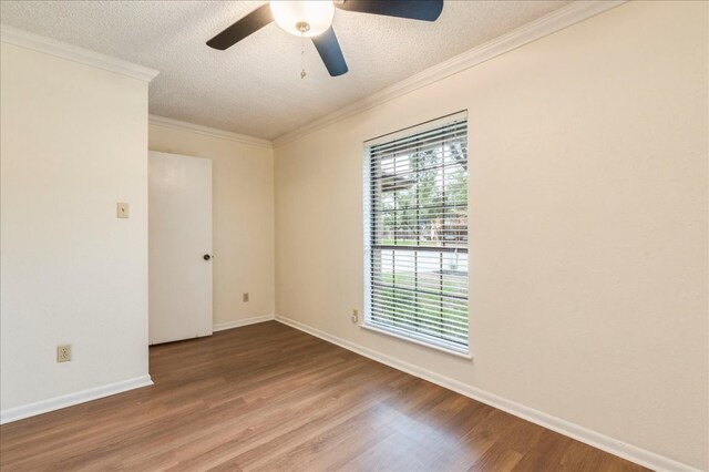 unfurnished room featuring a ceiling fan, a textured ceiling, crown molding, wood finished floors, and baseboards