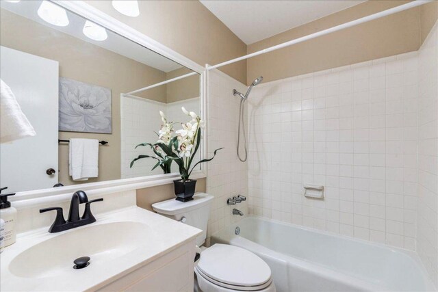 bathroom featuring vanity, toilet, and tub / shower combination