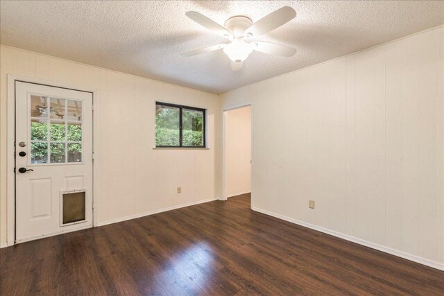empty room featuring baseboards, dark wood-style flooring, a textured ceiling, and ceiling fan