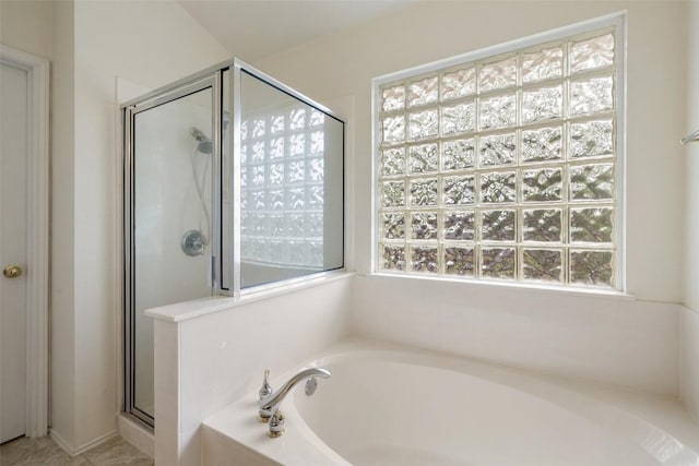 bathroom with a garden tub and a stall shower