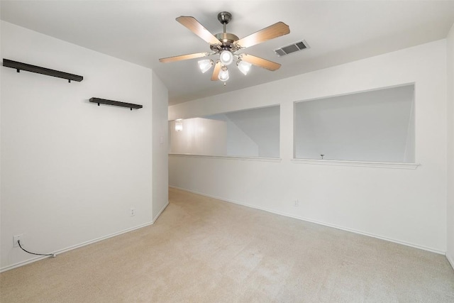 unfurnished room featuring visible vents, a ceiling fan, baseboards, and carpet floors