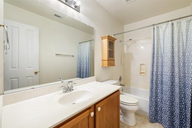 bathroom featuring tile patterned flooring, vanity, toilet, shower / bath combo with shower curtain, and visible vents