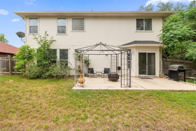 407 N Lori Cir, Bastrop, TX 78602 - back of property with an outdoor fire pit, a patio, and stucco siding