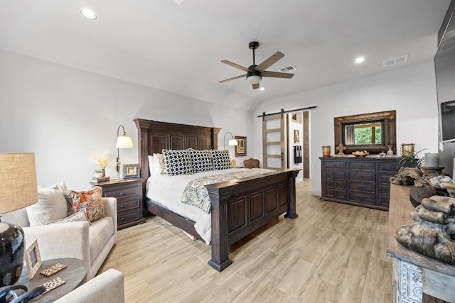 741 Faith Dr, Liberty Hill, TX 78642 - bedroom with a barn door, light wood finished floors, lofted ceiling, recessed lighting, and a ceiling fan