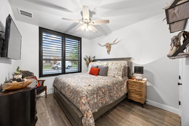 741 Faith Dr, Liberty Hill, TX 78642 - bedroom with wood finished floors, baseboards, and ceiling fan