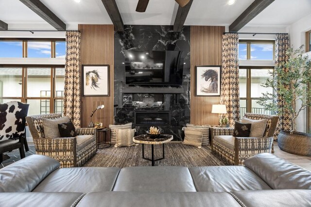 741 Faith Dr, Liberty Hill, TX 78642 - living room featuring beamed ceiling, a premium fireplace, and a ceiling fan
