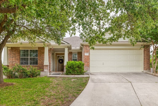 view of front of property featuring roof with shingles, brick siding, a garage, a front yard, and concrete driveway