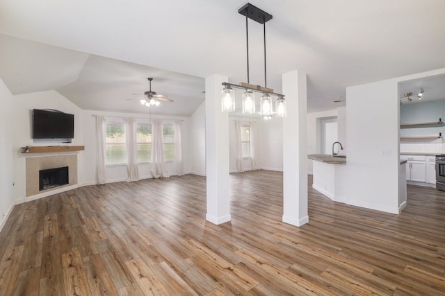 3339 Alexander Valley Cv, Round Rock, TX 78665 - unfurnished living room with a fireplace, a ceiling fan, wood finished floors, and lofted ceiling