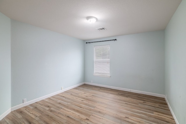 3339 Alexander Valley Cv, Round Rock, TX 78665 - spare room with light wood-style flooring and a textured ceiling
