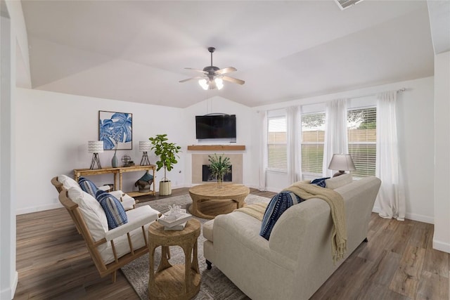 3339 Alexander Valley Cv, Round Rock, TX 78665 - living area featuring wood finished floors, a ceiling fan, a tile fireplace, and lofted ceiling