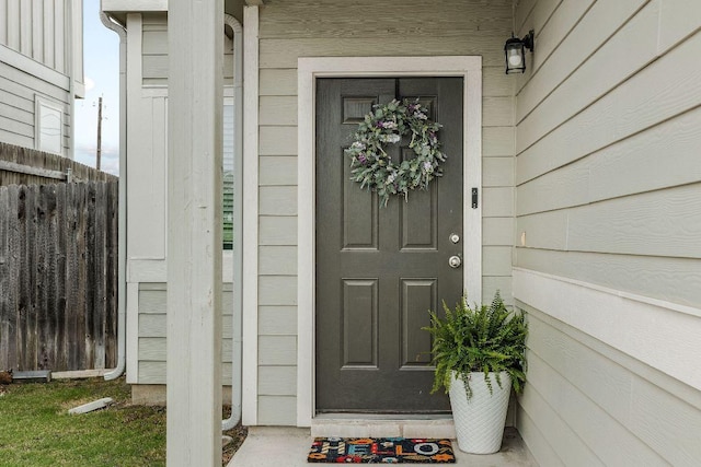 view of exterior entry with fence