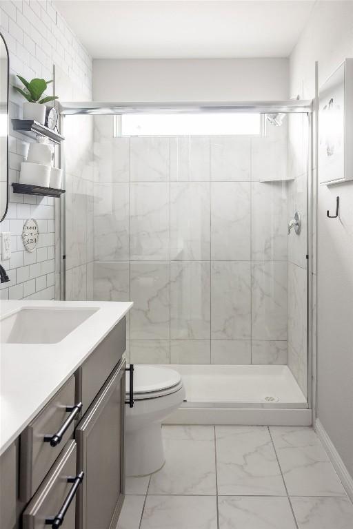 full bathroom with a shower stall, a healthy amount of sunlight, and marble finish floor