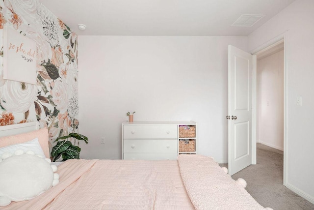 bedroom featuring baseboards, carpet flooring, and visible vents