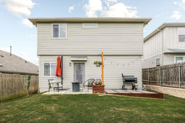 back of property with a lawn, a patio, and a fenced backyard
