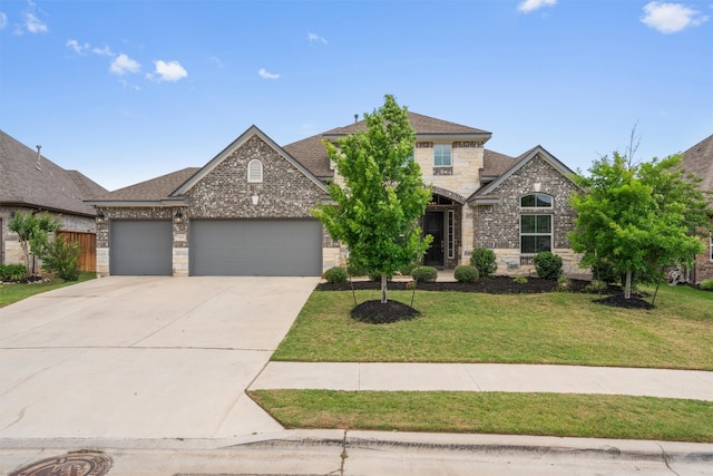 view of front of property featuring a shingled roof, an attached garage, a front lawn, stone siding, and concrete driveway