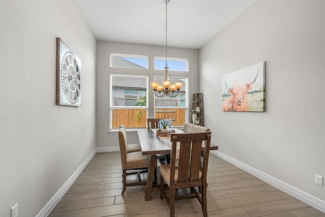 2217 Belen Dr, Leander, TX 78641 - dining space with a chandelier, wood finished floors, and baseboards