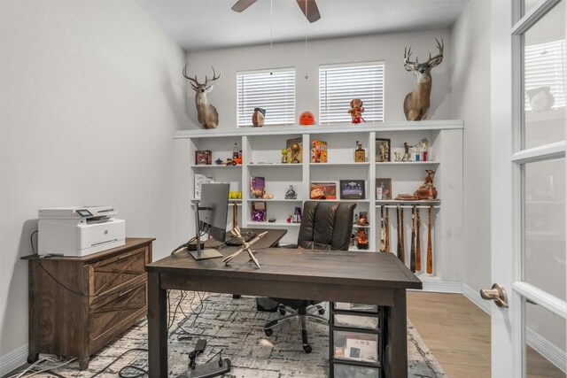 home office with baseboards, ceiling fan, wood finished floors, and a wealth of natural light