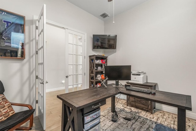 2217 Belen Dr, Leander, TX 78641 - home office with french doors, light wood finished floors, and baseboards